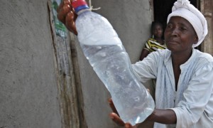 African woman with bottle of drinking water